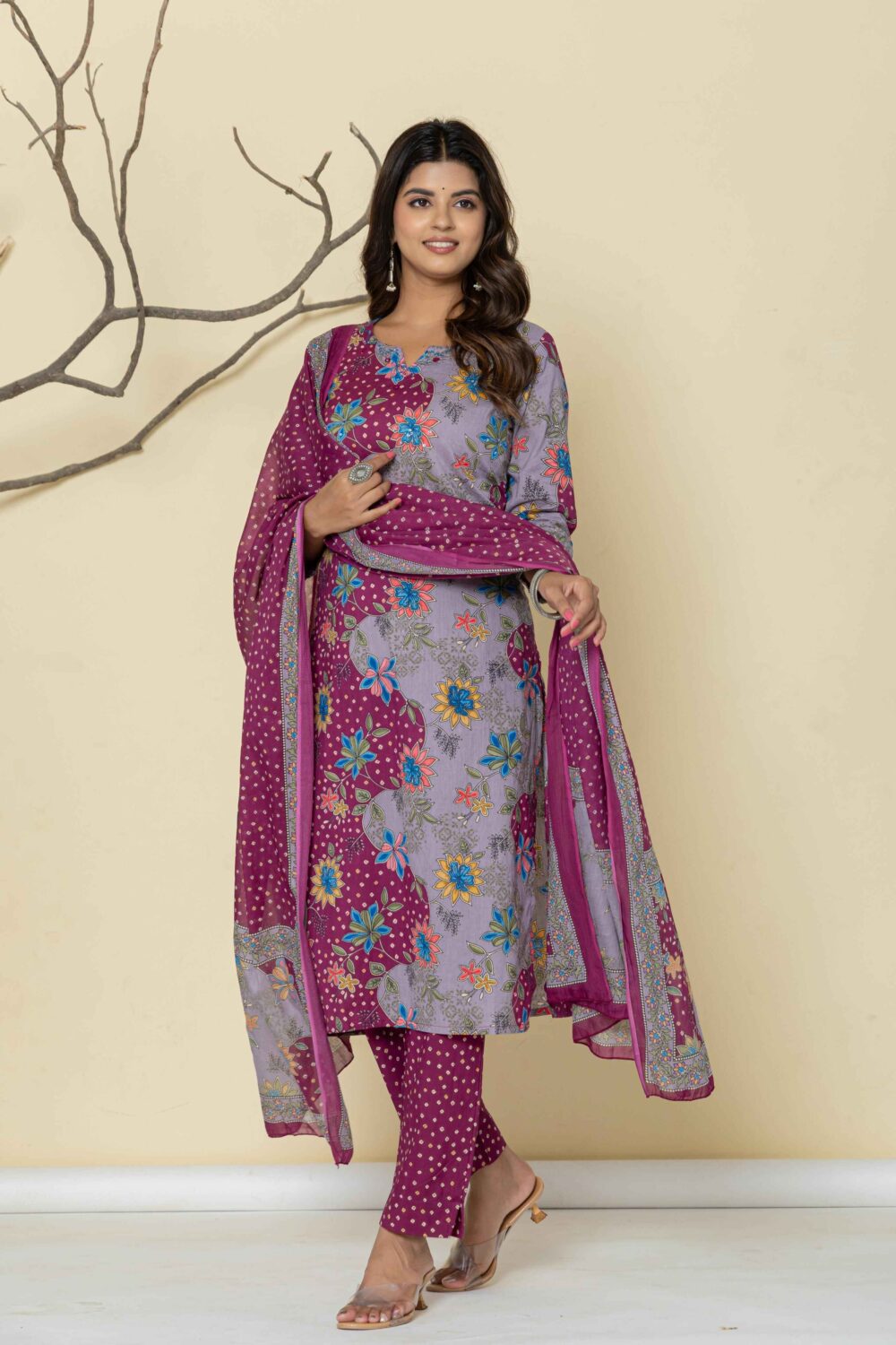Woman wearing a purple floral printed kurti pant dupatta set