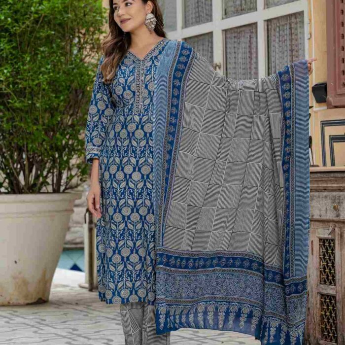 HK Vastra Indigo Blue Cotton Suit Set for women featuring floral block print kurta and geometric print dupatta standing in a heritage background