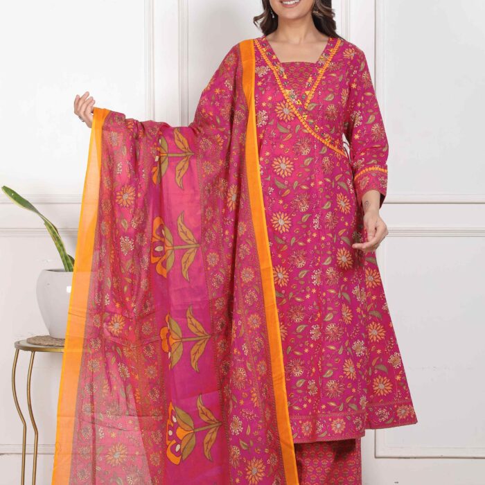 A woman wearing a bright magenta pink floral print cotton Anarkali suit with a matching palazzo and a pink dupatta