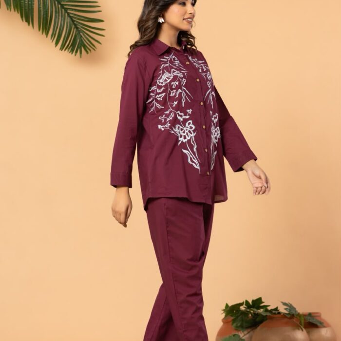 Maroon embroidered co-ord set for women featuring a full-sleeve shirt-style top with white floral embroidery and matching straight-fit pants.