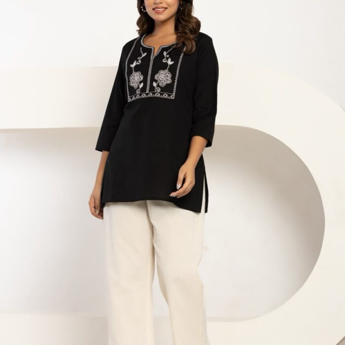 Women wearing a black cottonflex embroidered top and off-white trousers cord set from HK Vastra