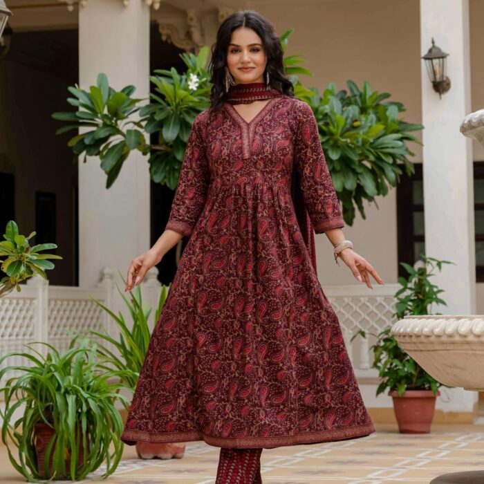 Woman wearing a maroon printed A-Line kurta set with matching pants and dupatta,